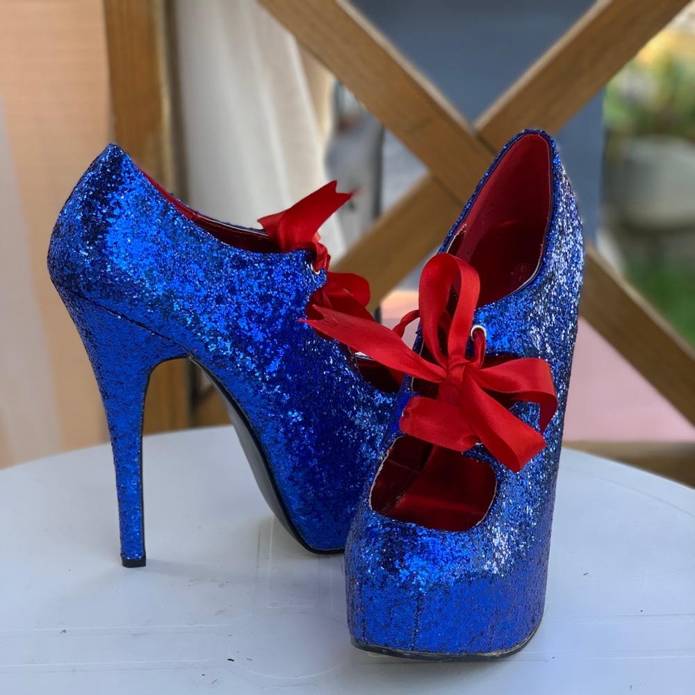Glitter blue Pleaser stilettos with red ribbon